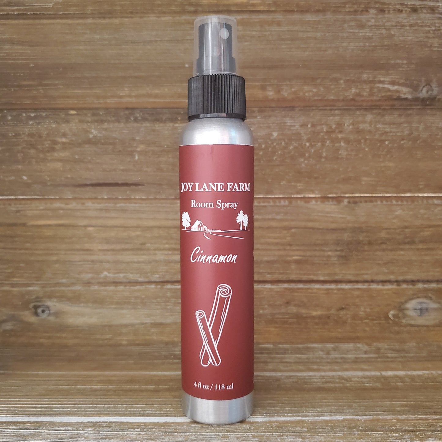 Room spray bottle with red label on a wooden background