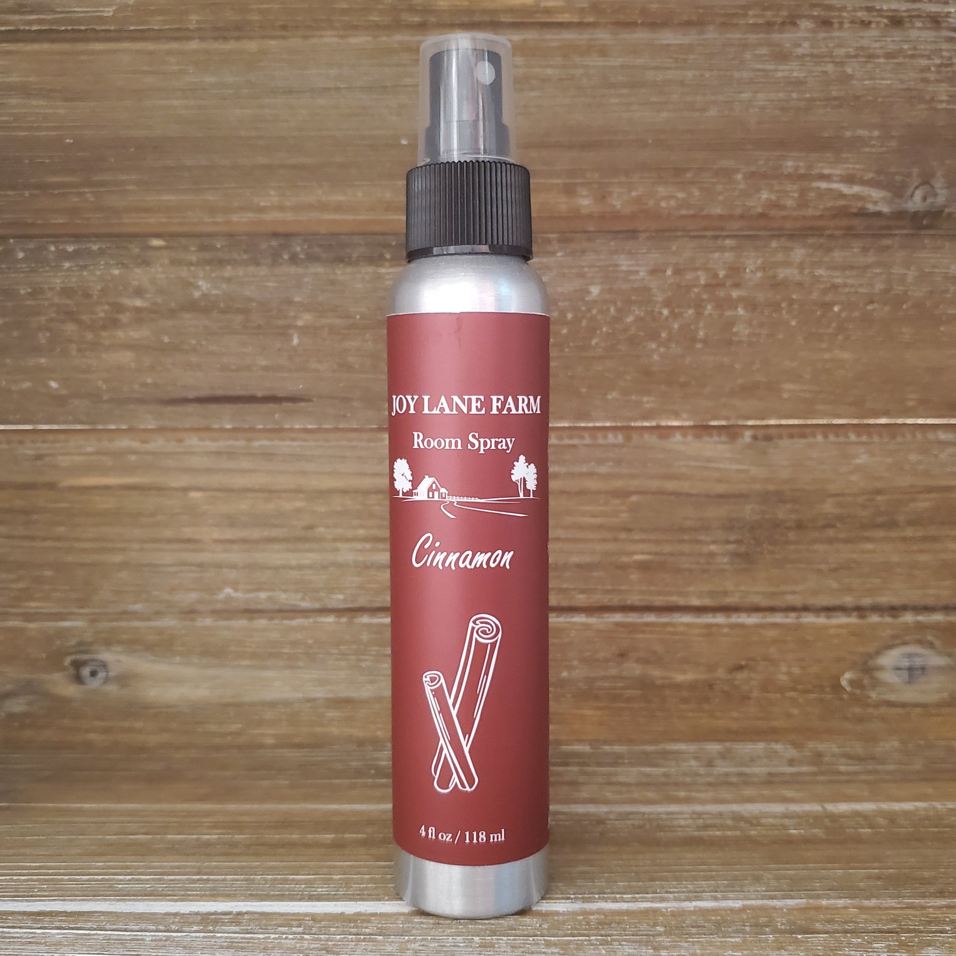 Room spray bottle with red label on a wooden background