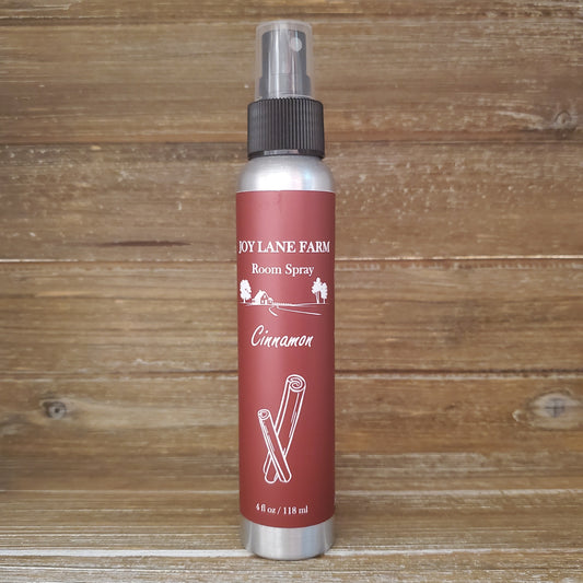 Room spray bottle with red label on a wooden background