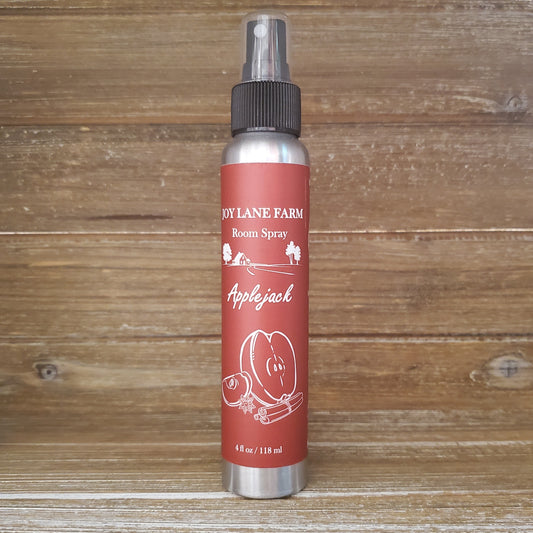 Room spray bottle labeled 'Apple Jack' from 'Dy Lane Farm' on a wooden background