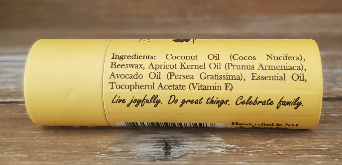 Yellow tube with black text on a wooden surface