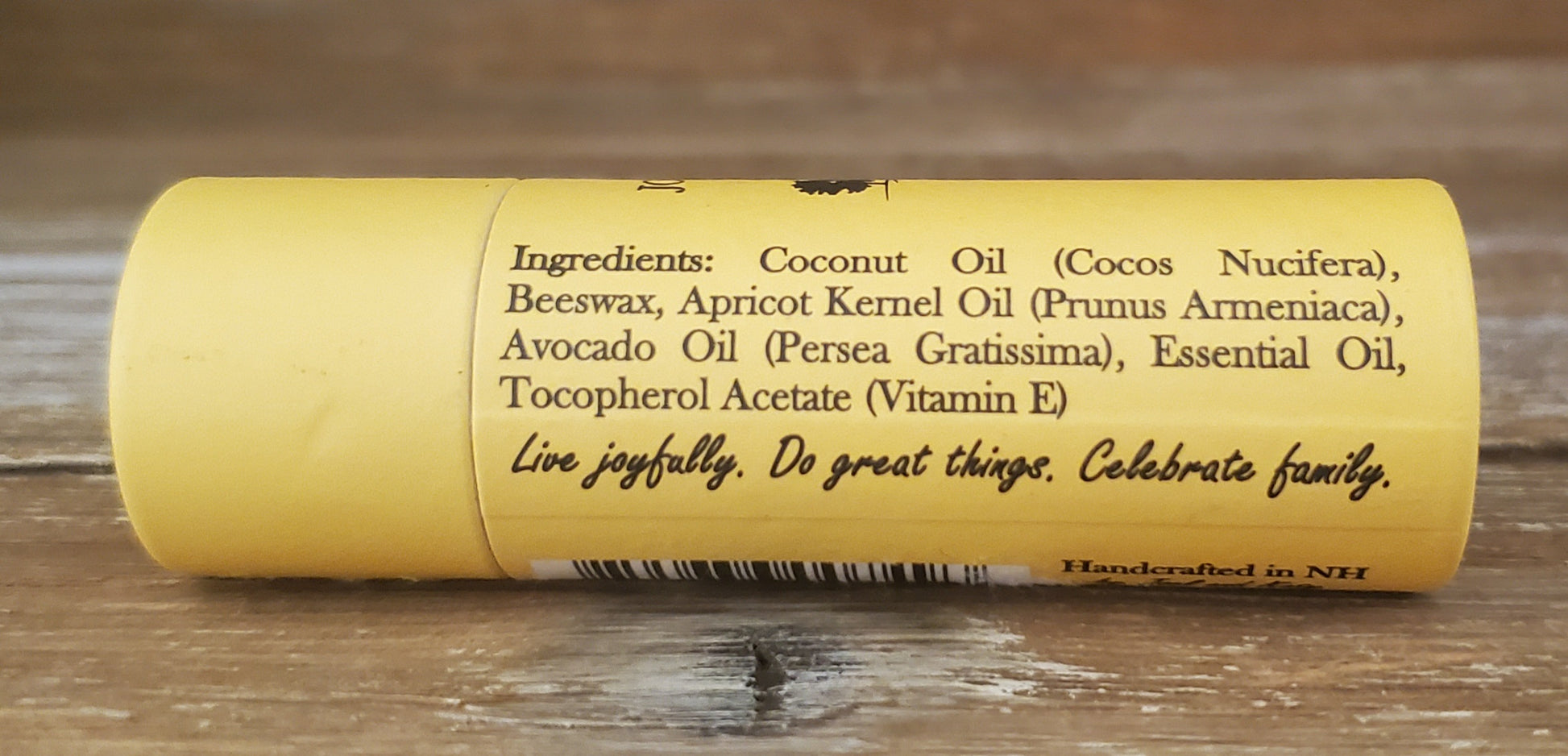 Yellow tube with black text on a wooden surface