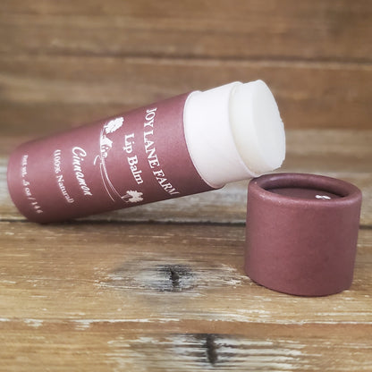 Lip balm with a wooden container on a wooden surface