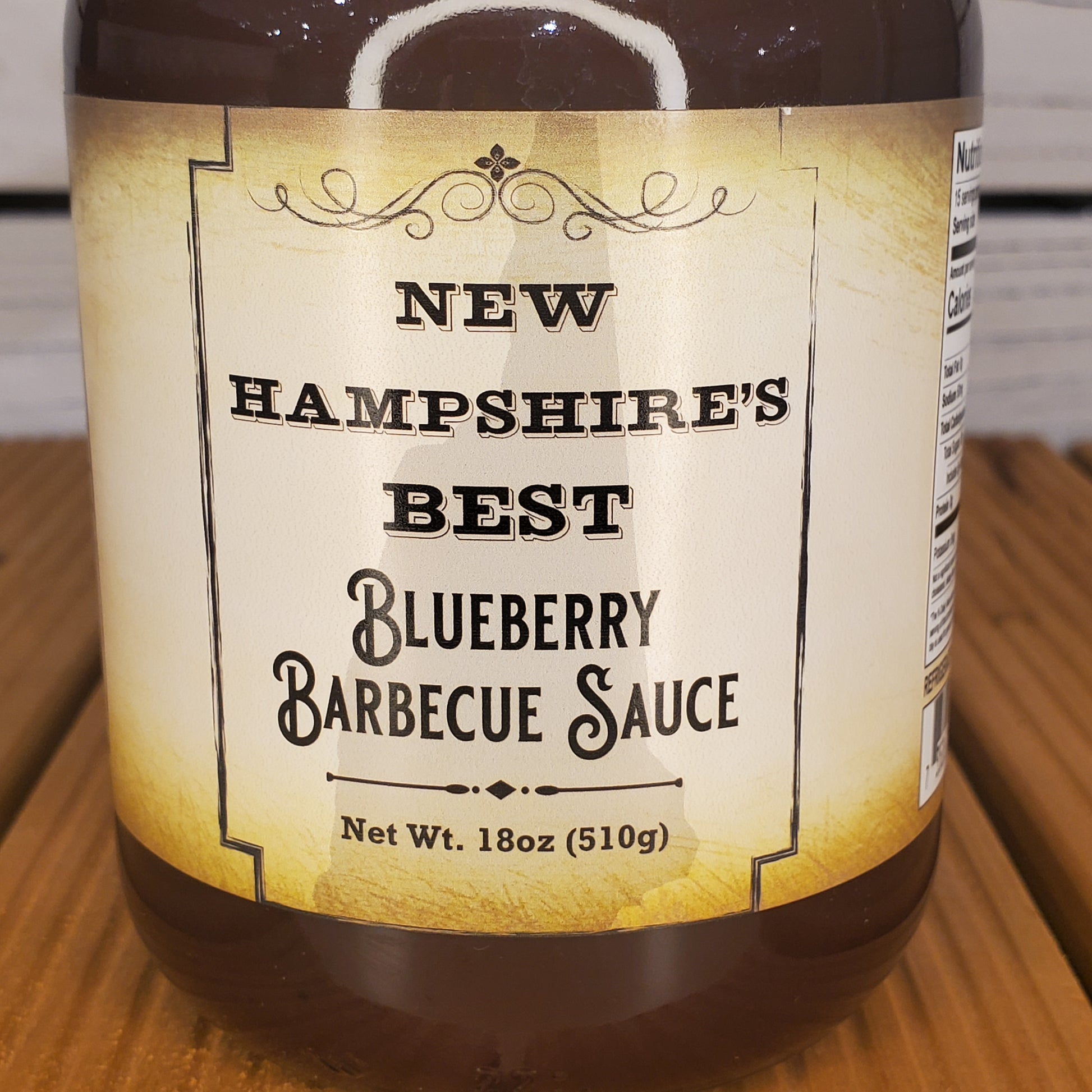 Bottle of New Hampshire's Best Blueberry Barbecue Sauce on a wooden surface