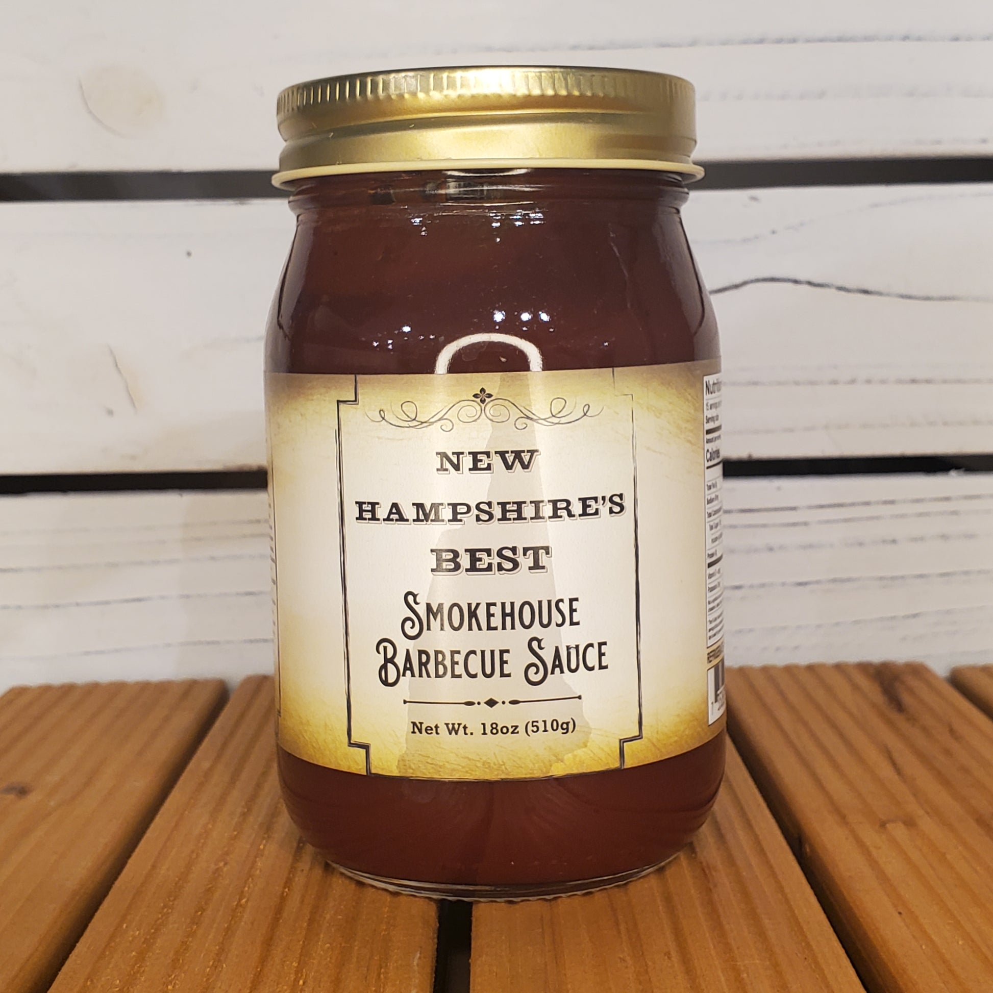 Jar of New Hampshire's Best Smokehouse Barbecue Sauce on a wooden surface