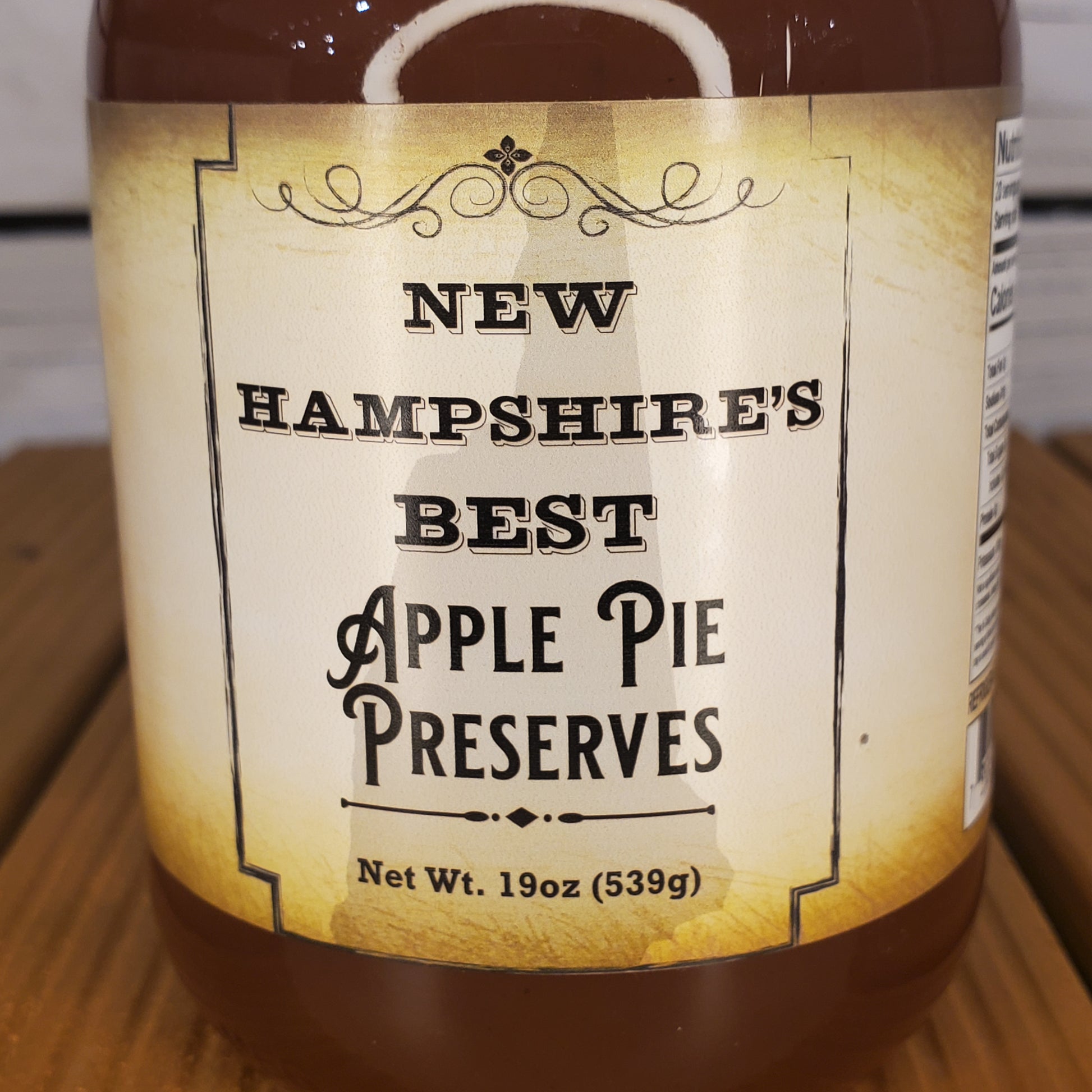 Jar of New Hampshire's Best Apple Pie Preserves on a wooden surface