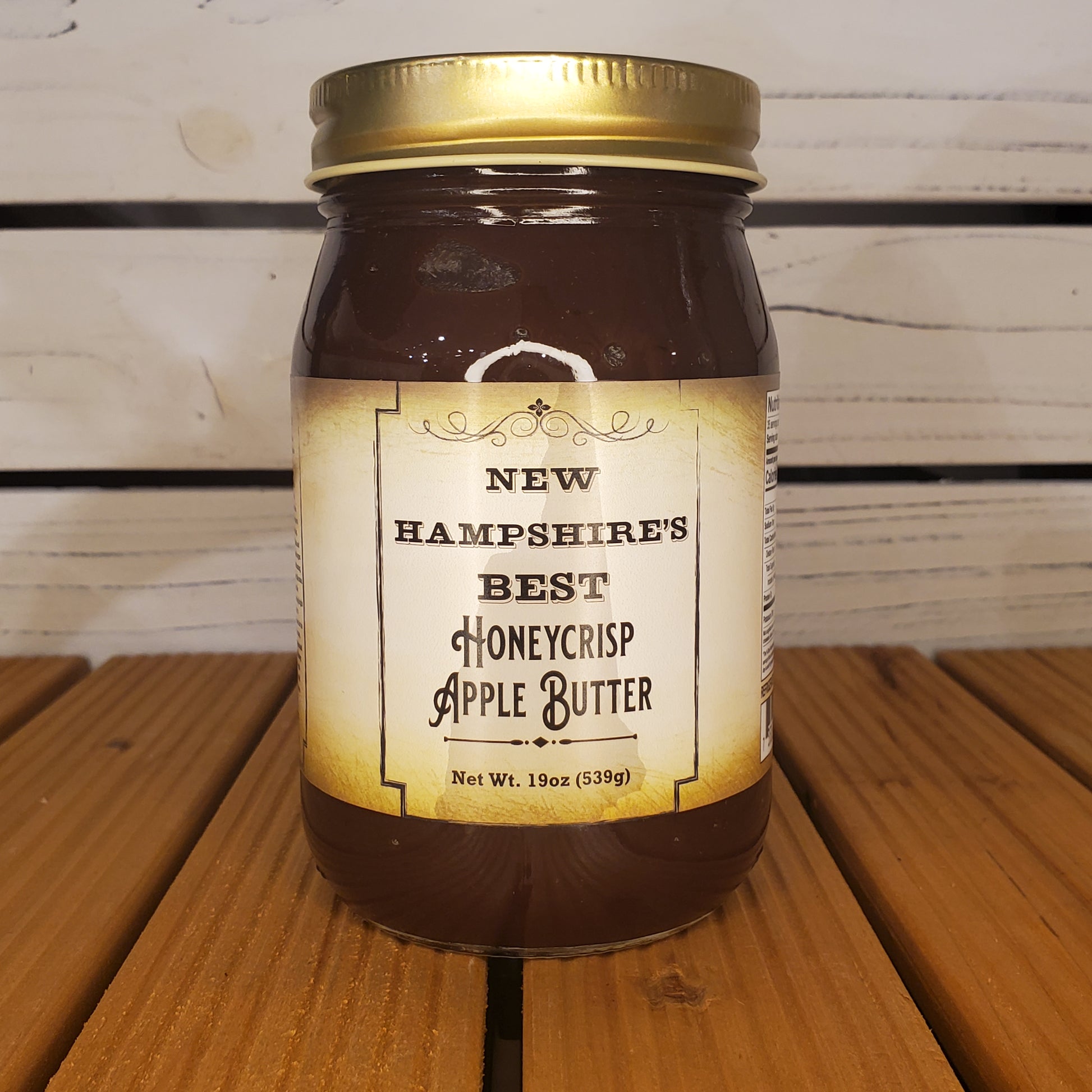 Jar of New Hampshire's Best Honeycrisp Apple Butter on a wooden surface