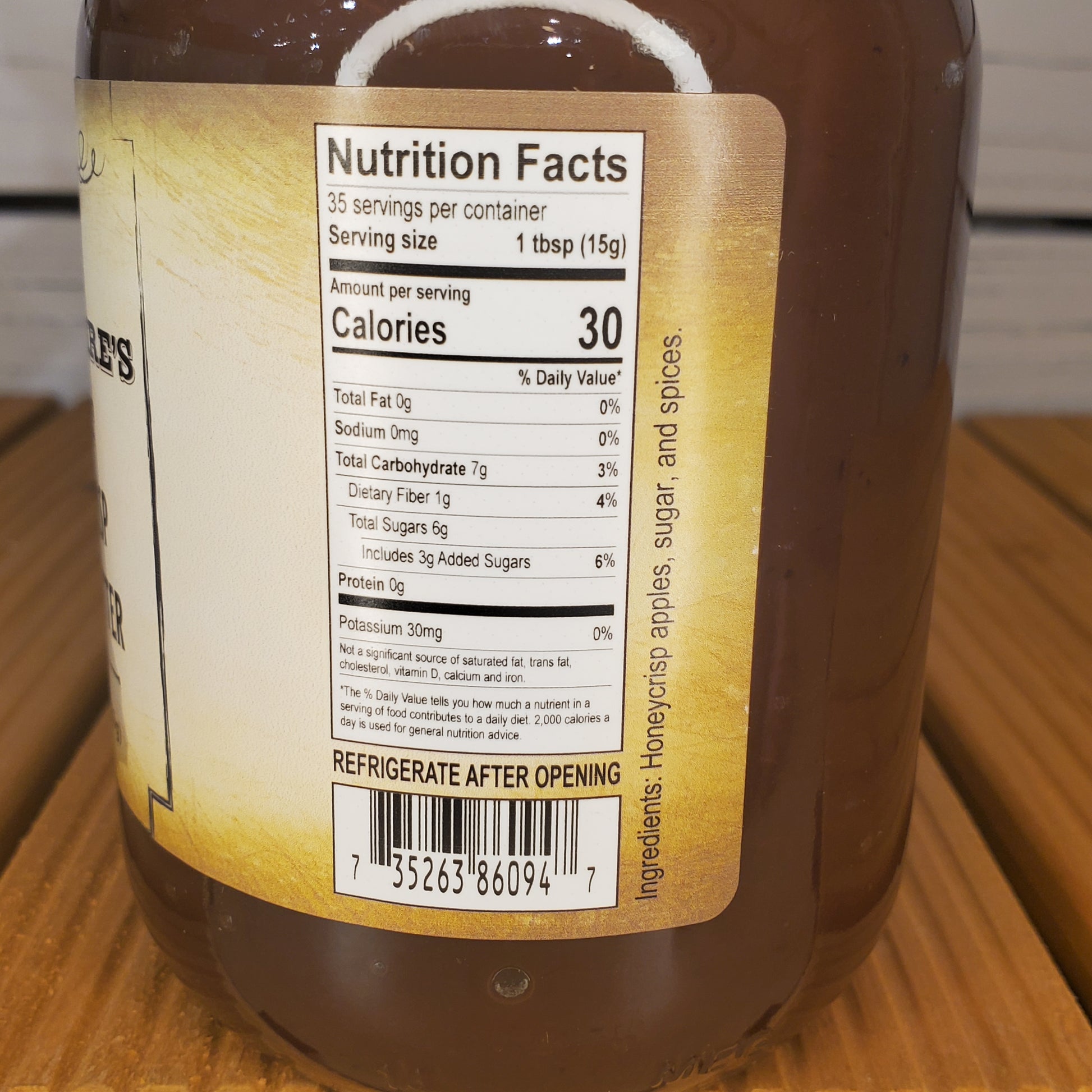 Close-up of a honey bottle label with nutrition facts on a wooden surface