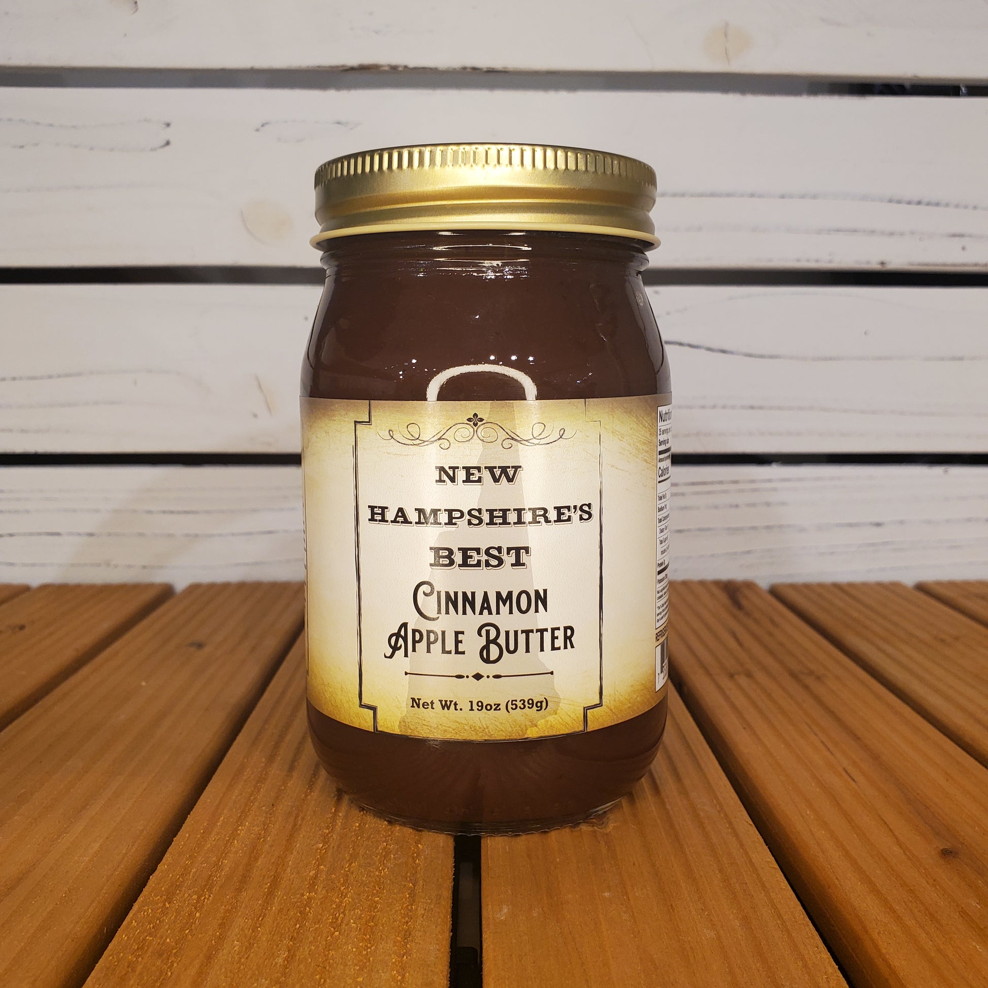 Jar of New Hampshire's Best Cinnamon Apple Butter on a wooden surface