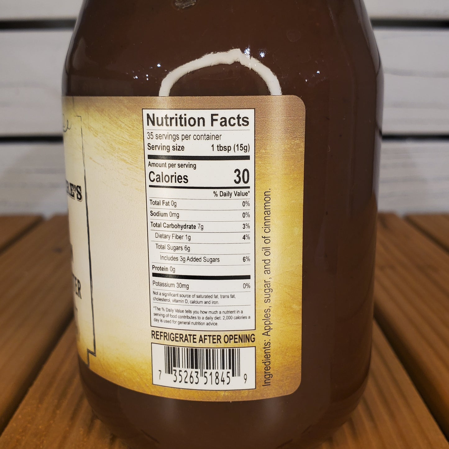 Close-up of a bottle label with nutritional information on a wooden surface