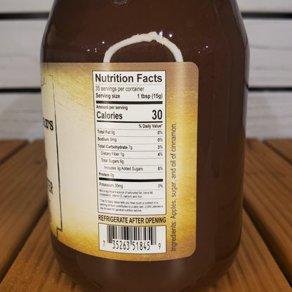 Close-up of a bottle label with nutritional information on a wooden surface