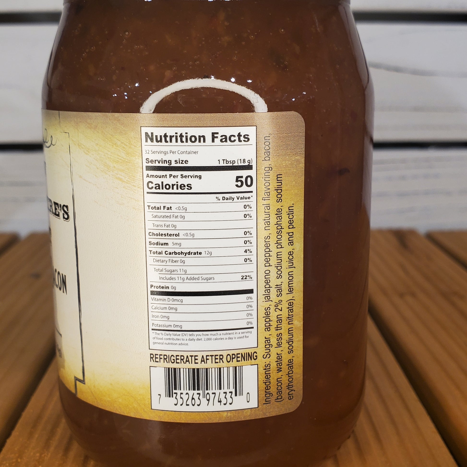 Close-up of a bottle label with nutritional information on a wooden surface