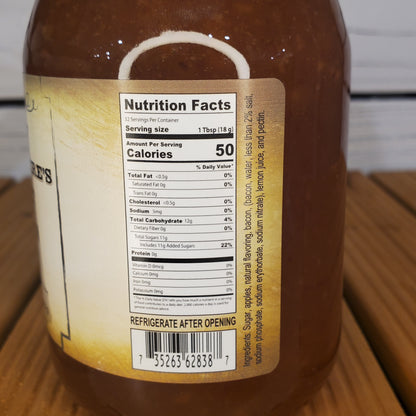 Nutrition facts label on a jar of sauce with a wooden surface in the background