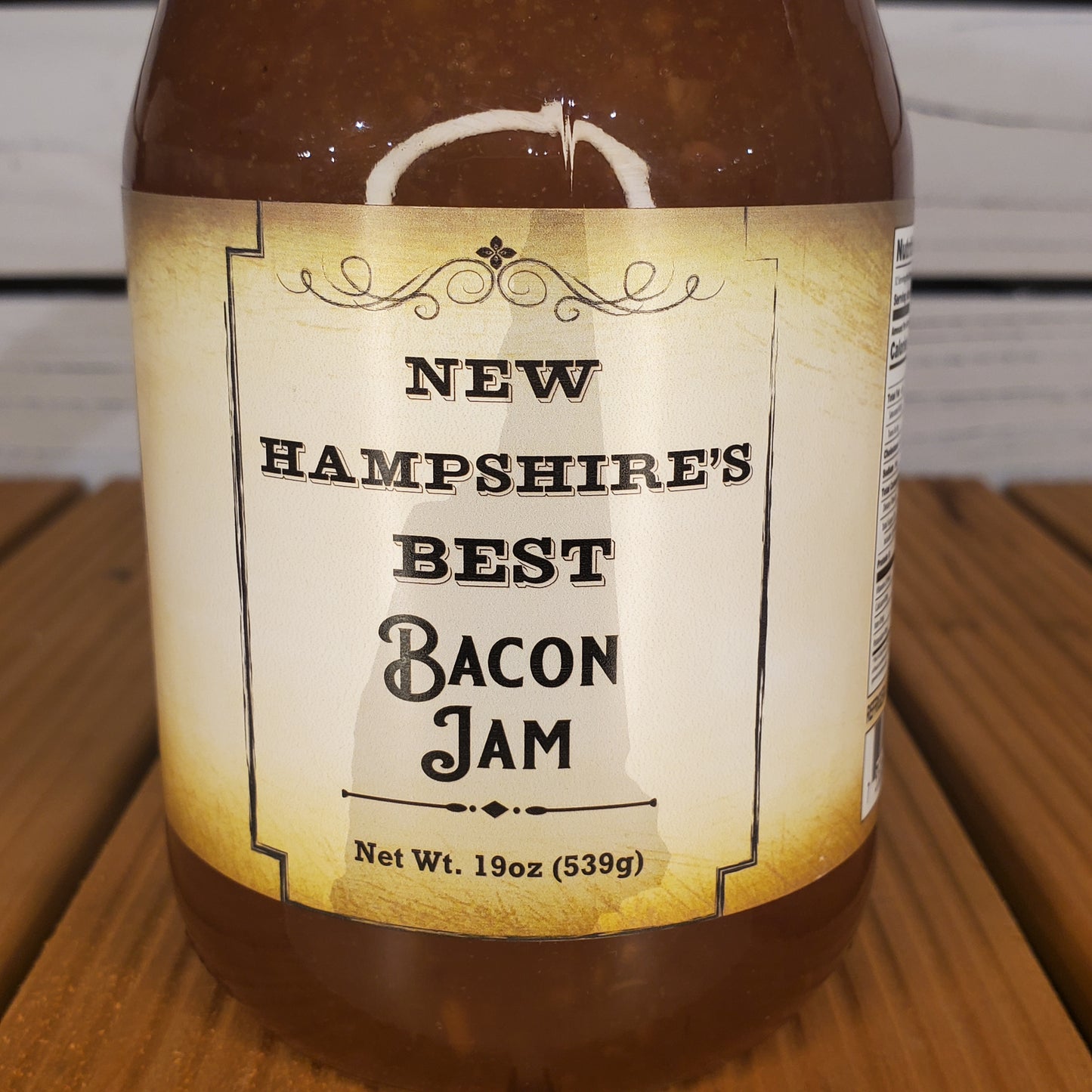 Bottle of New Hampshire's Best Bacon Jam on a wooden surface