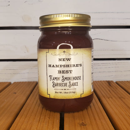 Jar of Flaming Smokehouse Barbecue Sauce on a wooden surface