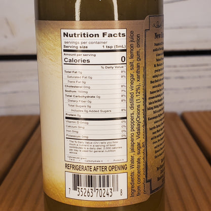 Close-up of a bottle label with nutritional information on a wooden surface