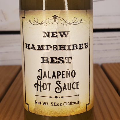 Bottle of New Hampshire's Best Jalapeño Hot Sauce with a rustic label.