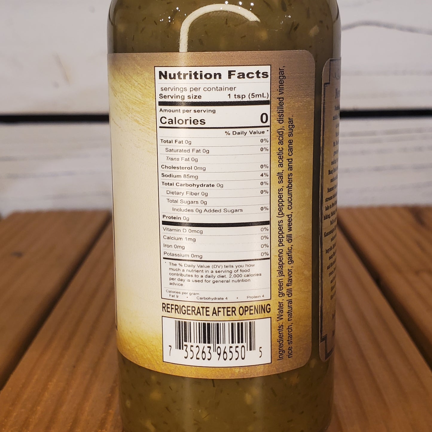 Close-up of a pickle jar label with nutrition facts on a wooden surface