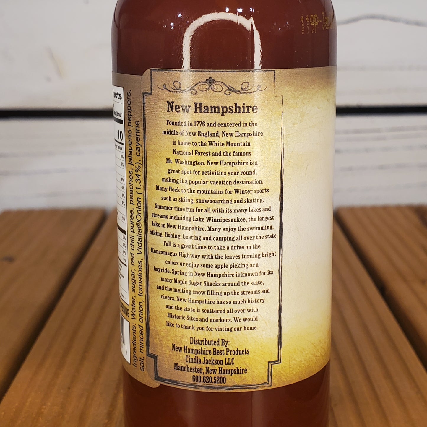 Bottle with a label about New Hampshire on a wooden surface