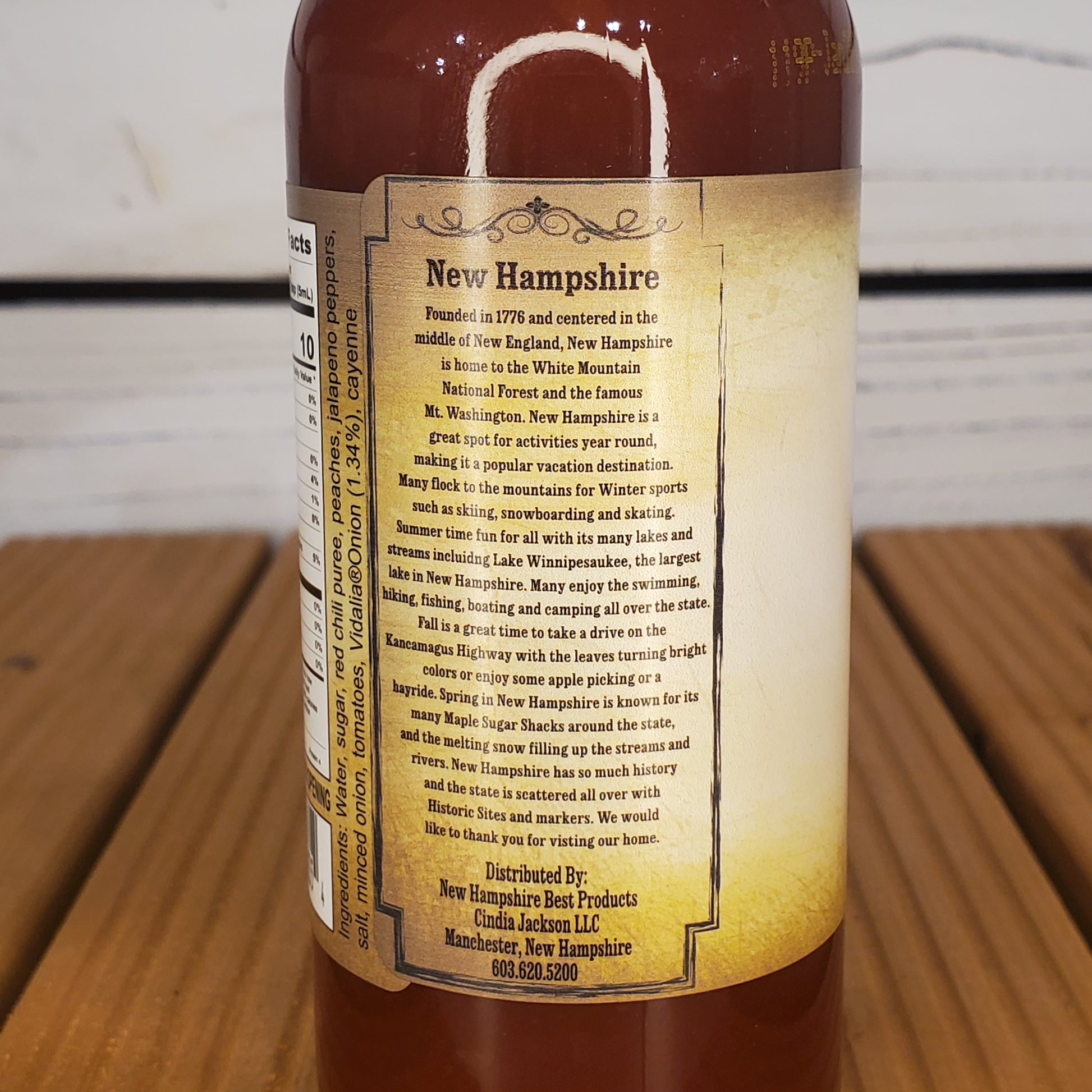 Bottle with a label about New Hampshire on a wooden surface
