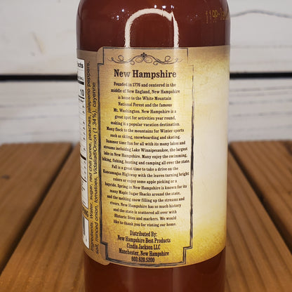 Bottle with a label about New Hampshire on a wooden surface