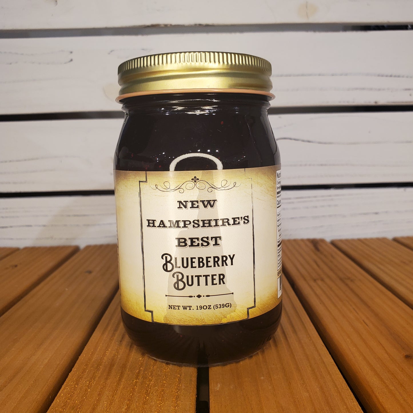 Jar of New Hampshire's Best Blueberry Butter on a wooden surface