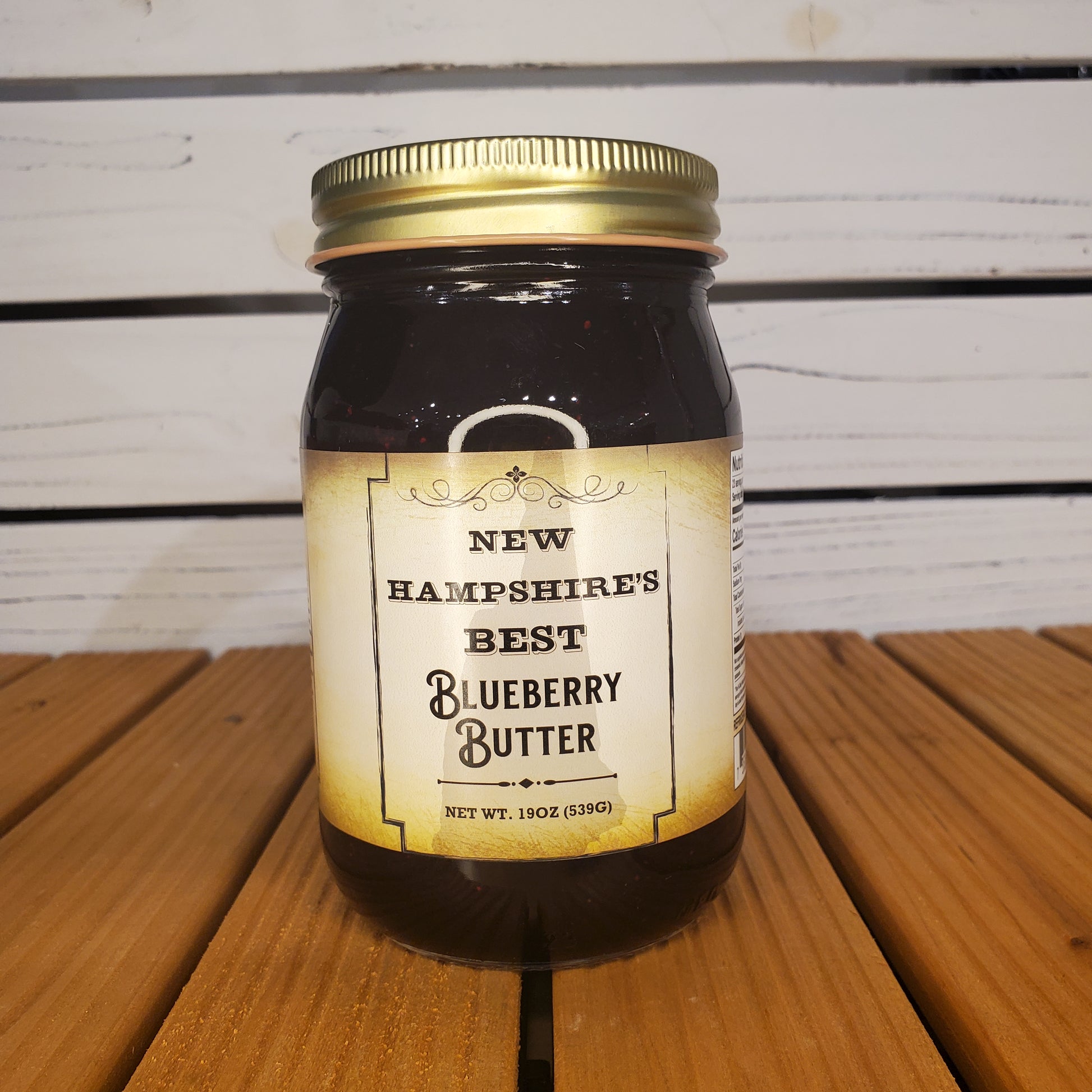 Jar of New Hampshire's Best Blueberry Butter on a wooden surface