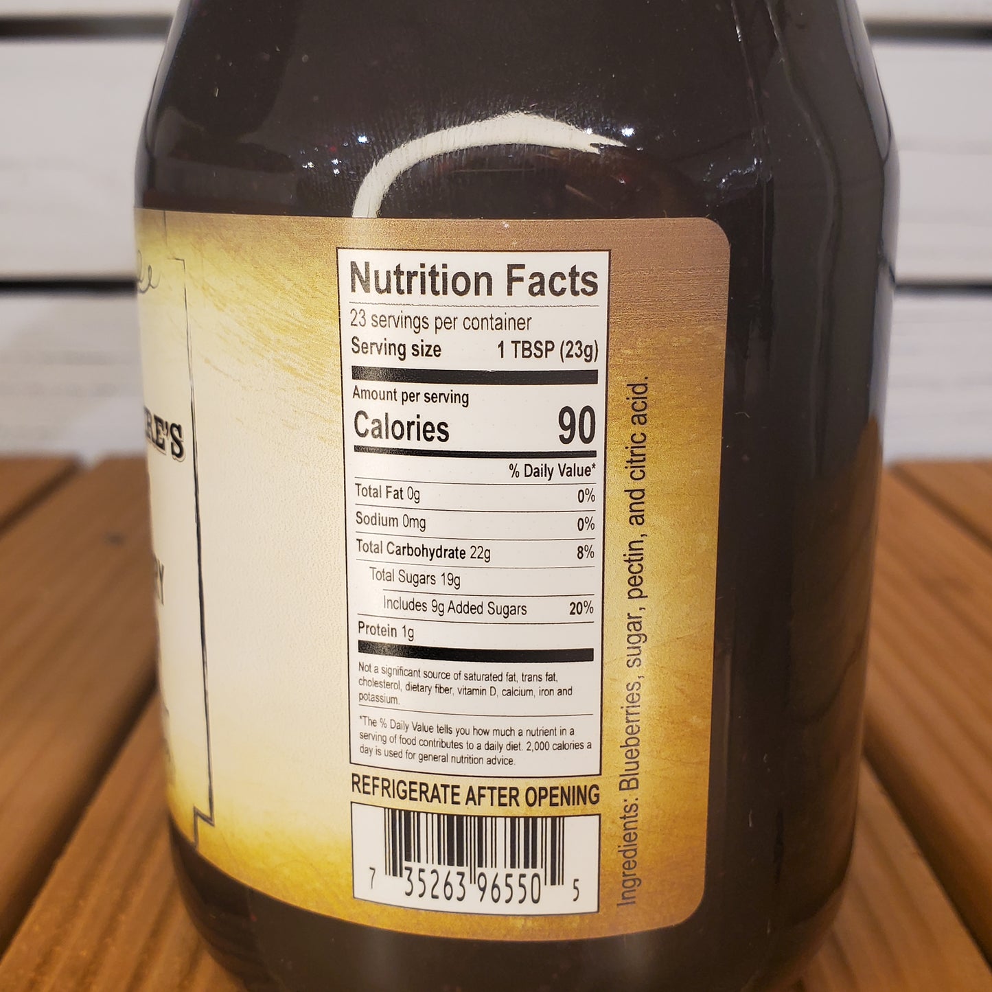 Close-up of a bottle label with nutrition facts on a wooden surface