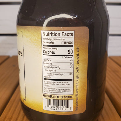 Close-up of a bottle label with nutrition facts on a wooden surface
