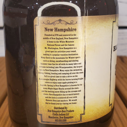 Bottle label with text about New Hampshire on a wooden surface