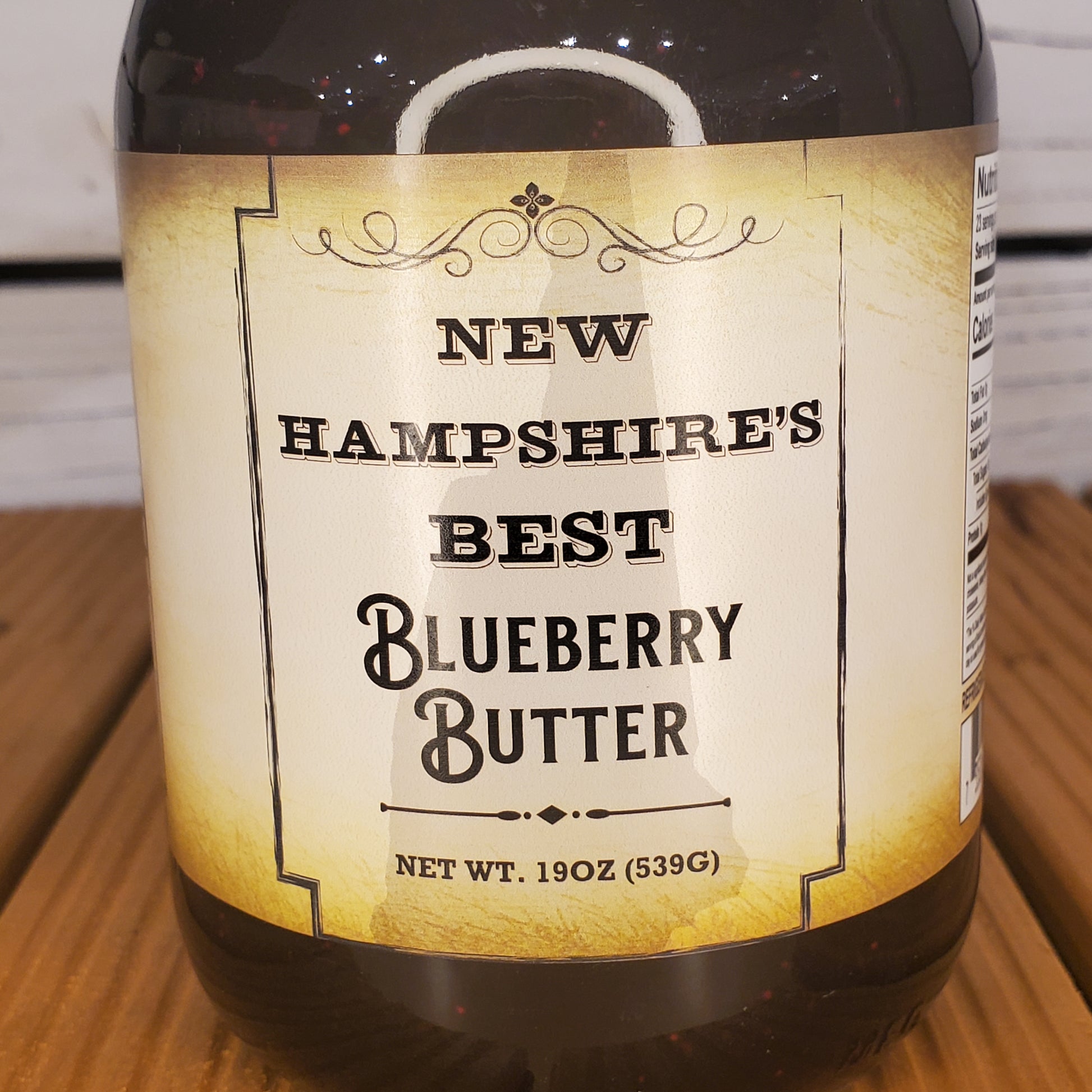 Bottle of New Hampshire's Best Blueberry Butter on a wooden surface