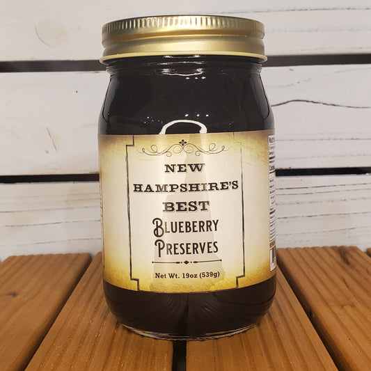 Jar of New Hampshire's Best Blueberry Preserves on a wooden surface