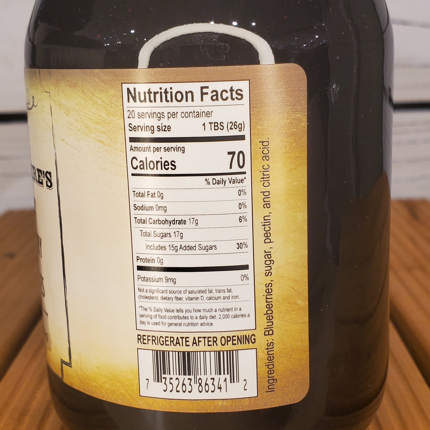 Close-up of a bottle label with nutritional information on a wooden surface