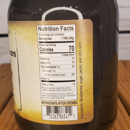 Close-up of a bottle label with nutritional information on a wooden surface