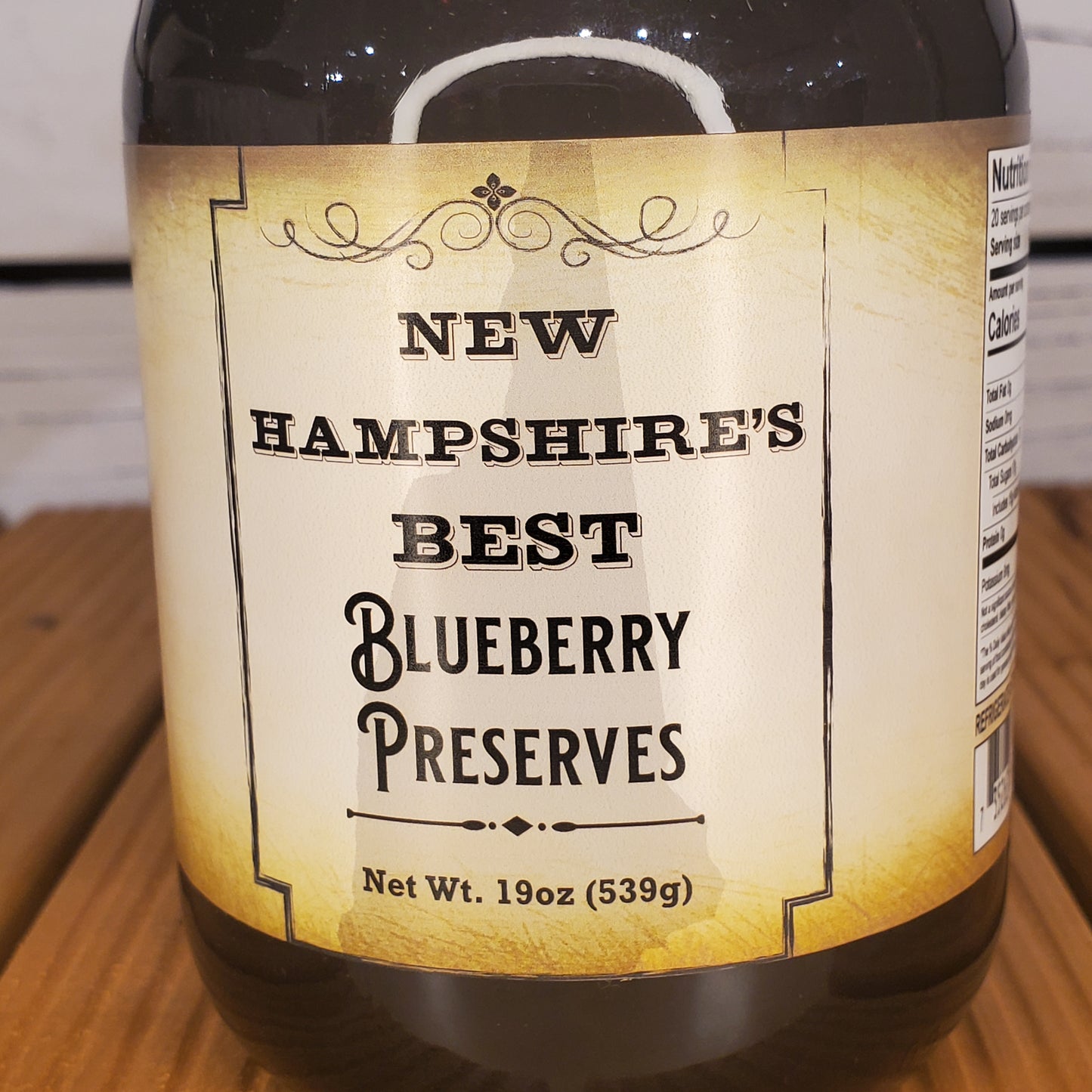 Jar of New Hampshire's Best Blueberry Preserves on a wooden surface