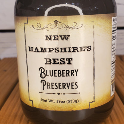 Jar of New Hampshire's Best Blueberry Preserves on a wooden surface