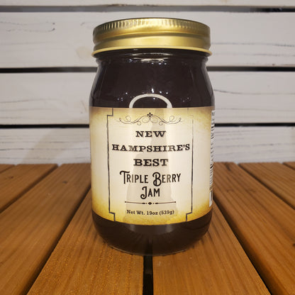 Jar of New Hampshire's Best Triple Berry Jam on a wooden surface