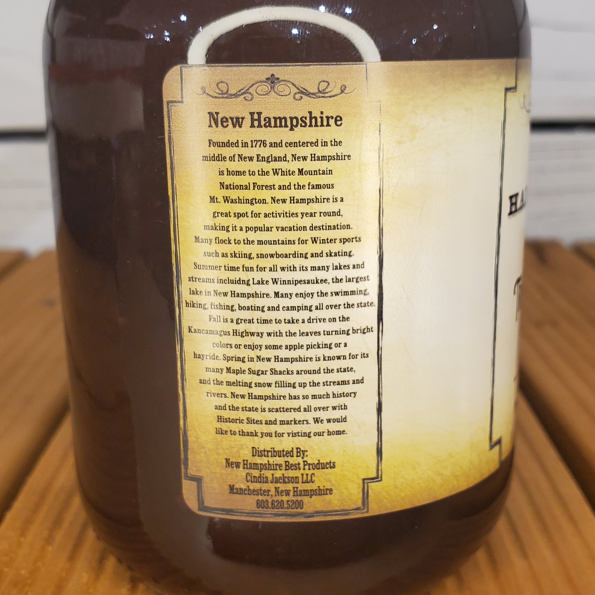 Bottle with a label about New Hampshire on a wooden surface