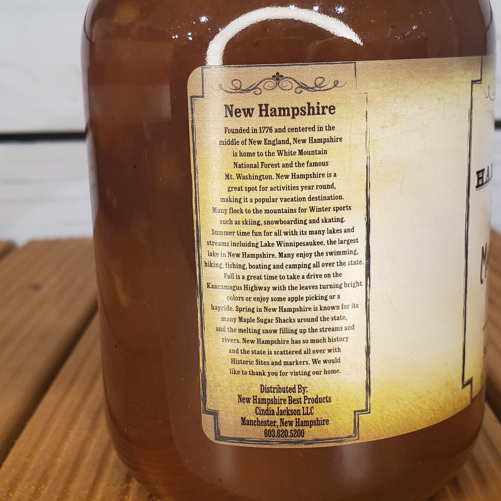 Bottle with a label about New Hampshire on a wooden surface