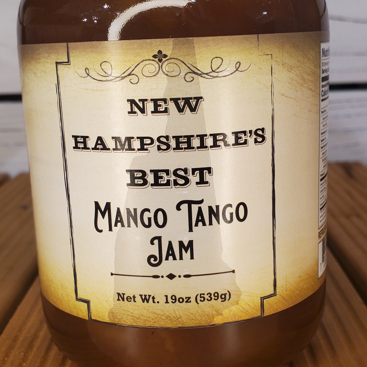 Jar of New Hampshire's Best Mango Tango Jam with a decorative label.