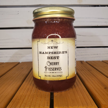 Jar of New Hampshire's Best Cherry Preserves on a wooden surface