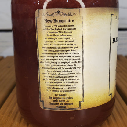 Bottle of New Hampshire apple juice with a label on a wooden surface
