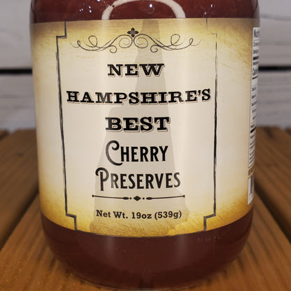 Jar of New Hampshire's Best Cherry Preserves on a wooden surface
