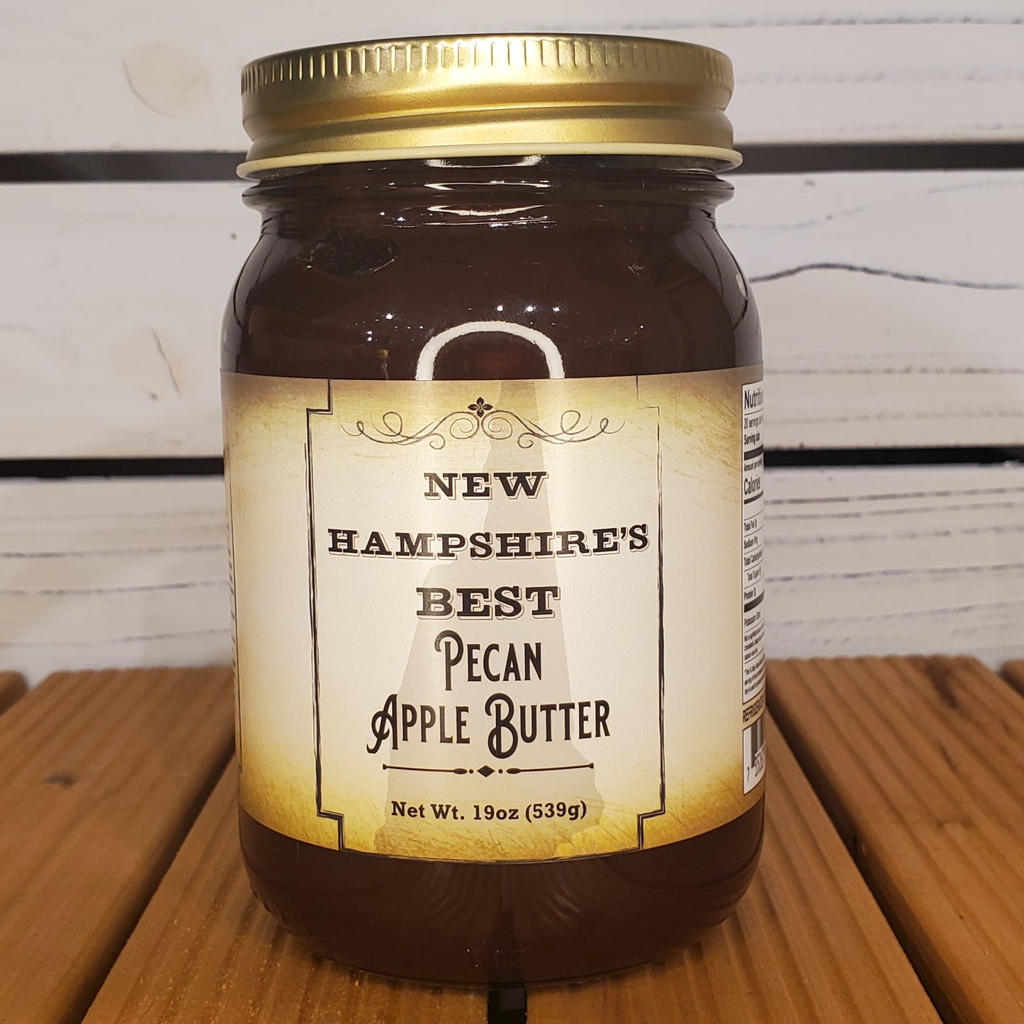 Jar of New Hampshire's Best Pecan Apple Butter on a wooden surface