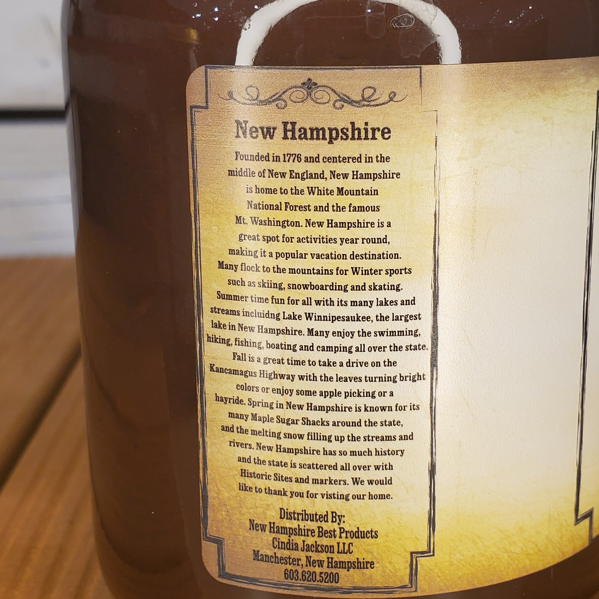 Mug with a New Hampshire-themed label on a wooden surface