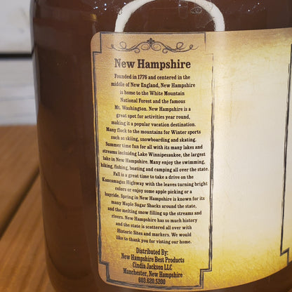 Mug with a New Hampshire-themed label on a wooden surface