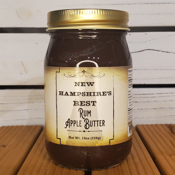 Jar of New Hampshire's Best Rum Apple Butter on a wooden surface