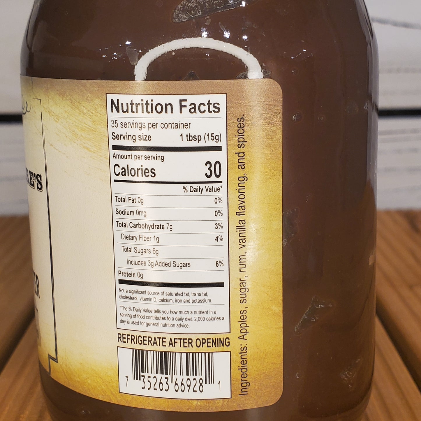 Close-up of a bottle label with nutrition facts on a wooden surface