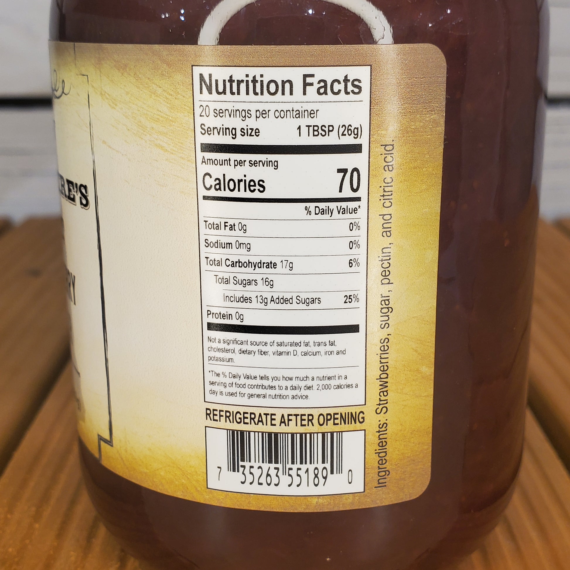 Close-up of a bottle label with nutrition facts on a wooden surface