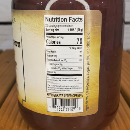 Close-up of a bottle label with nutrition facts on a wooden surface